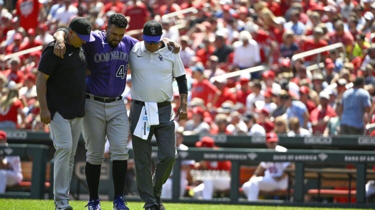 Aug 18, 2022; St. Louis, Missouri, USA;  Colorado Rockies starting pitcher Antonio Senzatela (49) is helped off the field after injuring his leg while cover first base against the St. Louis Cardinals during the second inning at Busch Stadium. Mandatory Credit: Jeff Curry-USA TODAY Sports