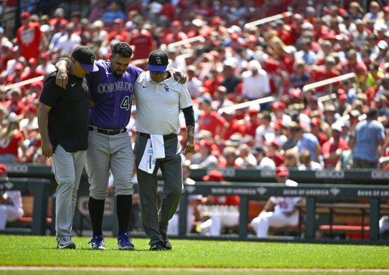 Aug 18, 2022; St. Louis, Missouri, USA;  Colorado Rockies starting pitcher Antonio Senzatela (49) is helped off the field after injuring his leg while cover first base against the St. Louis Cardinals during the second inning at Busch Stadium. Mandatory Credit: Jeff Curry-USA TODAY Sports