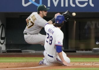 Aug 18, 2022; Arlington, Texas, USA; Texas Rangers catcher Jonah Heim (28) slides as he is tagged out at home by Oakland Athletics starting pitcher Zach Logue (67) during the second inning at Globe Life Field. Mandatory Credit: Jim Cowsert-USA TODAY Sports