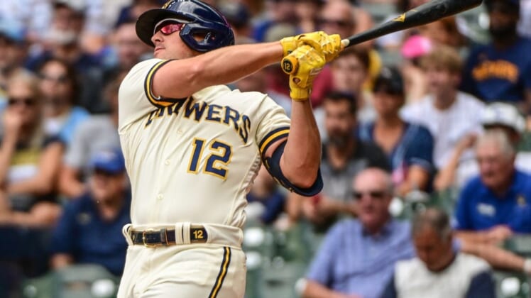Aug 18, 2022; Milwaukee, Wisconsin, USA; Milwaukee Brewers right fielder Hunter Renfroe (12) hits a two-run home run in the fifth inning against the Los Angeles Dodgers at American Family Field. Mandatory Credit: Benny Sieu-USA TODAY Sports