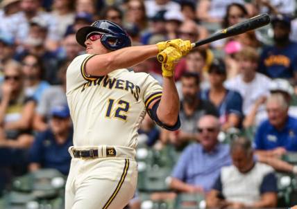 Aug 18, 2022; Milwaukee, Wisconsin, USA; Milwaukee Brewers right fielder Hunter Renfroe (12) hits a two-run home run in the fifth inning against the Los Angeles Dodgers at American Family Field. Mandatory Credit: Benny Sieu-USA TODAY Sports