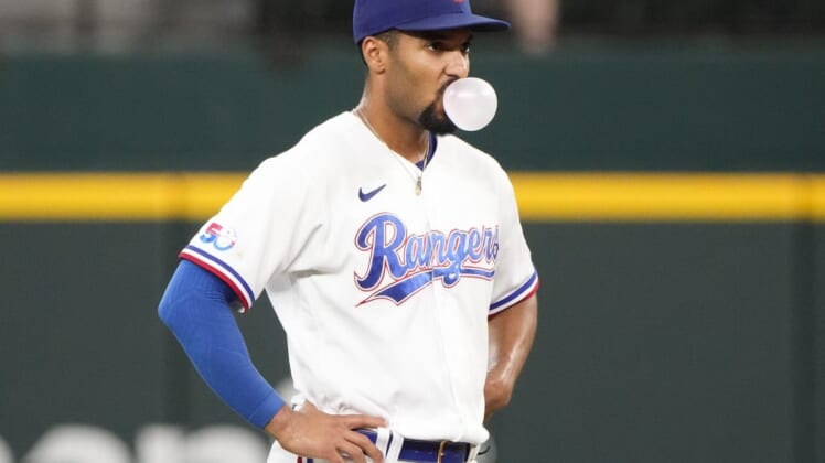Aug 18, 2022; Arlington, Texas, USA; Texas Rangers second baseman Marcus Semien (2) pauses to blow a bubble between pitches to the Oakland Athletics during the seventh inning at Globe Life Field. Mandatory Credit: Jim Cowsert-USA TODAY Sports