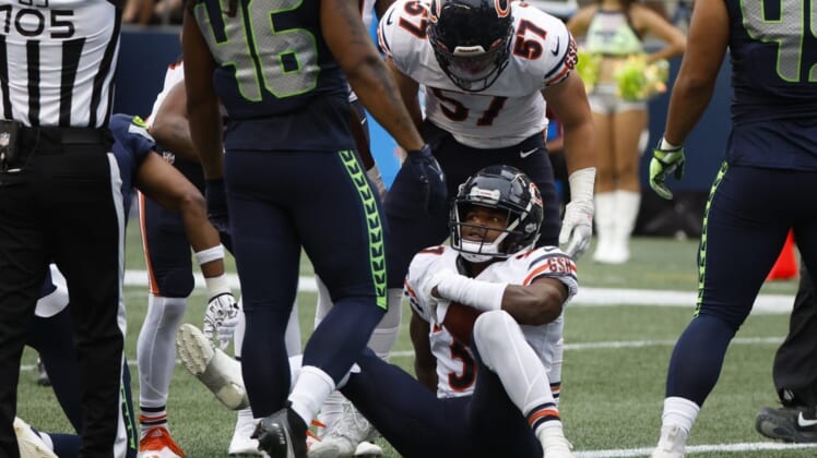 Aug 18, 2022; Seattle, Washington, USA; Chicago Bears safety Elijah Hicks (37) is helped up by teammates, including linebacker Jack Sanborn (57), after recovering a fumble for a touchdown against the Seattle Seahawks during the second quarter at Lumen Field. Mandatory Credit: Joe Nicholson-USA TODAY Sports