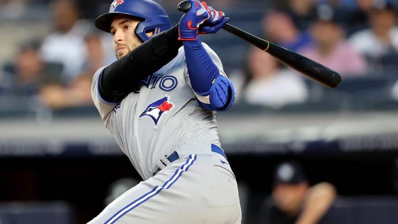 Aug 18, 2022; Bronx, New York, USA; Toronto Blue Jays designated hitter George Springer (4) follows through on an RBI single against the New York Yankees during the second inning at Yankee Stadium. Mandatory Credit: Brad Penner-USA TODAY Sports