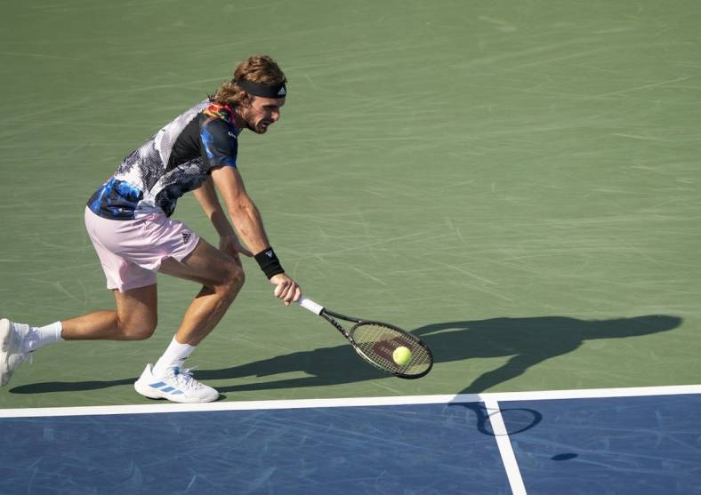 Aug 19, 2022; Cincinnati, OH, USA; Stefanos Tsitsipas (GRE) returns a shot during his match against John Isner (USA) at the Western & Southern Open at the Lindner Family Tennis Center. Mandatory Credit: Susan Mullane-USA TODAY Sports