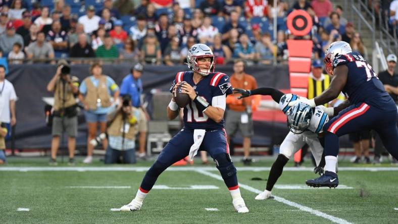 Aug 19, 2022; Foxborough, Massachusetts, USA; New England Patriots quarterback Mac Jones (10) drops back to pass during the first half of a preseason game against the Carolina Panthersat Gillette Stadium. Mandatory Credit: Eric Canha-USA TODAY Sports