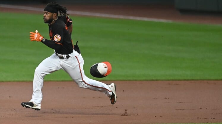 Aug 19, 2022; Baltimore, Maryland, USA; Baltimore Orioles center fielder Cedric Mullins (31) looses his helmet while running out a first inning doubler against the Boston Red Sox  at Oriole Park at Camden Yards. Mandatory Credit: Tommy Gilligan-USA TODAY Sports