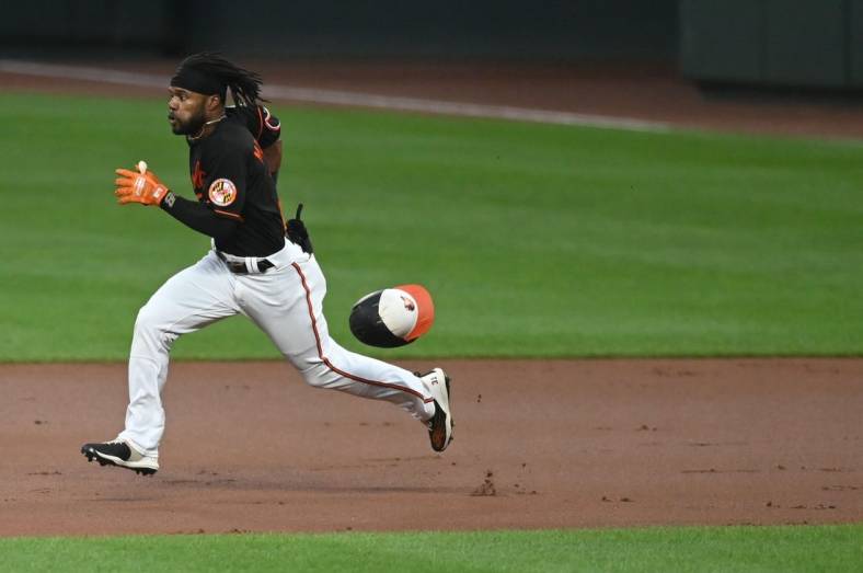Aug 19, 2022; Baltimore, Maryland, USA; Baltimore Orioles center fielder Cedric Mullins (31) looses his helmet while running out a first inning doubler against the Boston Red Sox  at Oriole Park at Camden Yards. Mandatory Credit: Tommy Gilligan-USA TODAY Sports