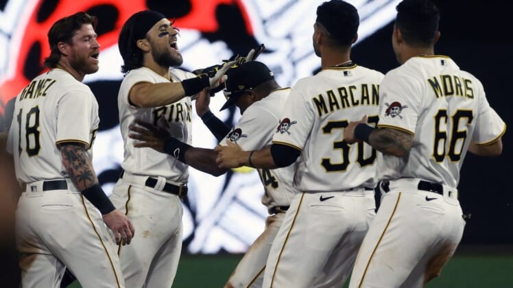 Aug 19, 2022; Pittsburgh, Pennsylvania, USA;  Pittsburgh Pirates first baseman Michael Chavis (second from left) celebrates his game winning walk-off single with teammates to defeat the Cincinnati Reds during the ninth inning at PNC Park. The Pirates won 5-4. Mandatory Credit: Charles LeClaire-USA TODAY Sports