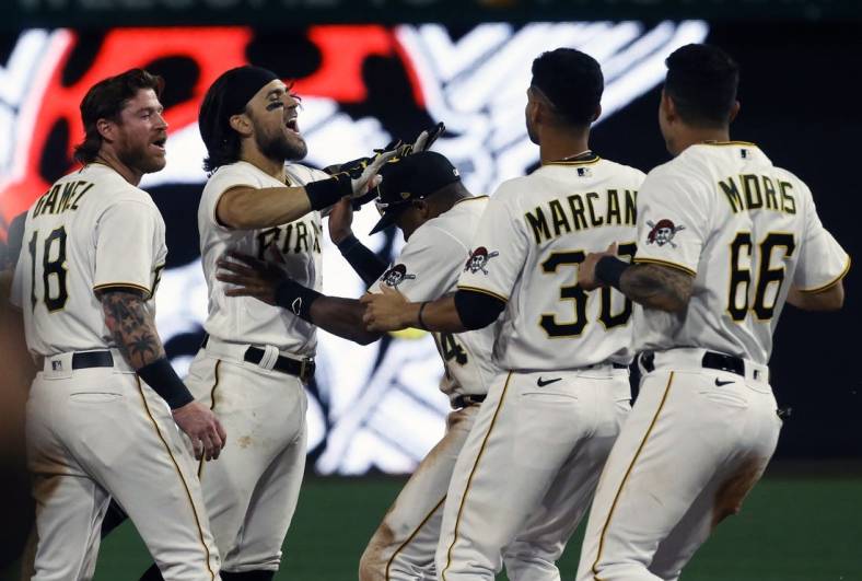 Aug 19, 2022; Pittsburgh, Pennsylvania, USA;  Pittsburgh Pirates first baseman Michael Chavis (second from left) celebrates his game winning walk-off single with teammates to defeat the Cincinnati Reds during the ninth inning at PNC Park. The Pirates won 5-4. Mandatory Credit: Charles LeClaire-USA TODAY Sports
