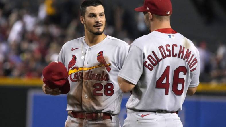 Aug 19, 2022; Phoenix, Arizona, USA; St. Louis Cardinals third baseman Nolan Arenado (28) talks to first baseman Paul Goldschmidt (46) in between innings against the Arizona Diamondbacks at Chase Field. Mandatory Credit: Rick Scuteri-USA TODAY Sports