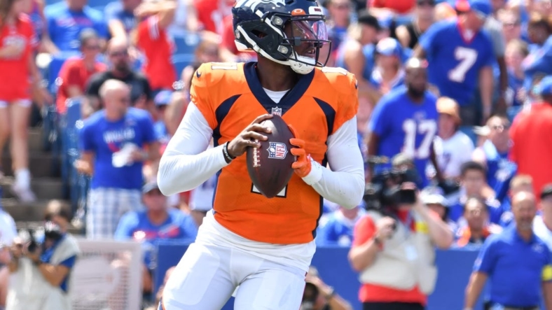 Aug 20, 2022; Orchard Park, New York, USA; Denver Broncos quarterback Josh Johnson (11) drops back to pass in the first quarter of a pre-season game against the Buffalo Bills at Highmark Stadium. Mandatory Credit: Mark Konezny-USA TODAY Sports