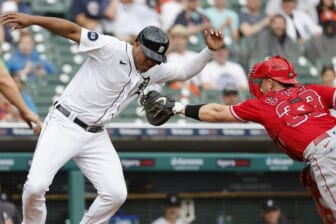 Aug 20, 2022; Detroit, Michigan, USA;  Detroit Tigers second baseman Jonathan Schoop (7) avoids the first tag by Los Angeles Angels catcher Max Stassi (33) in the third inning at Comerica Park. Mandatory Credit: Rick Osentoski-USA TODAY Sports