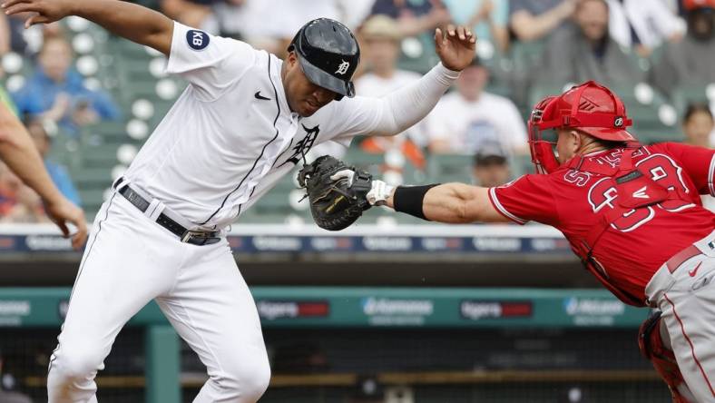 Aug 20, 2022; Detroit, Michigan, USA;  Detroit Tigers second baseman Jonathan Schoop (7) avoids the first tag by Los Angeles Angels catcher Max Stassi (33) in the third inning at Comerica Park. Mandatory Credit: Rick Osentoski-USA TODAY Sports