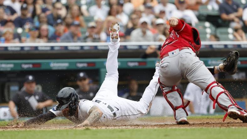 Aug 20, 2022; Detroit, Michigan, USA;  Detroit Tigers designated hitter Eric Haase (13) dives in safe at home ahead of the tag by Los Angeles Angels catcher Max Stassi (33) in the third inning at Comerica Park. Mandatory Credit: Rick Osentoski-USA TODAY Sports