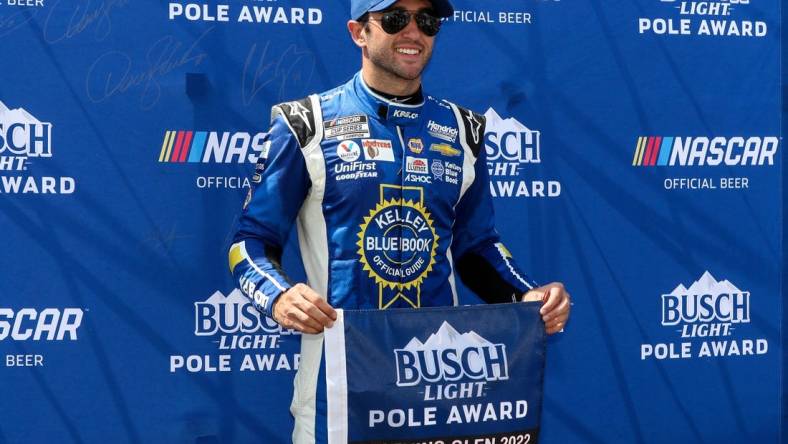 Aug 20, 2022; Watkins Glen, New York, USA; NASCAR Cup Series driver Chase Elliott stands with the pole award after winning the pole during practice and qualifying for the Go Bowling at The Glen at Watkins Glen International. Mandatory Credit: Matthew OHaren-USA TODAY Sports