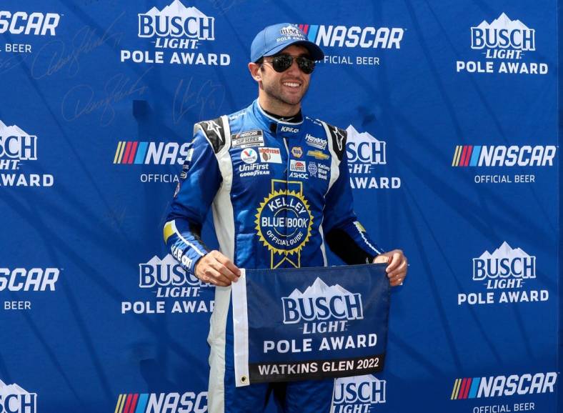 Aug 20, 2022; Watkins Glen, New York, USA; NASCAR Cup Series driver Chase Elliott stands with the pole award after winning the pole during practice and qualifying for the Go Bowling at The Glen at Watkins Glen International. Mandatory Credit: Matthew OHaren-USA TODAY Sports