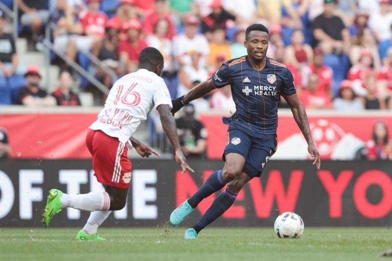 Aug 20, 2022; Harrison, New Jersey, USA; FC Cincinnati defender Alvas Powell (2) plays the ball againstNew York Red Bulls midfielder Dru Yearwood (16) during the first half at Red Bull Arena. Mandatory Credit: Vincent Carchietta-USA TODAY Sports