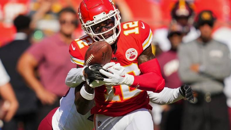 Aug 20, 2022; Kansas City, Missouri, USA; Kansas City Chiefs wide receiver Josh Gordon (12) catches a pass against Washington Commanders cornerback Corn Elder (26) during the second half at GEHA Field at Arrowhead Stadium. Mandatory Credit: Jay Biggerstaff-USA TODAY Sports