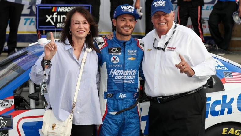 Aug 20, 2022; Watkins Glen, New York, USA; NASCAR Xfinity Series driver Kyle Larson celebrates with owner Rick Hendrick (right) and his wife Linda Hendrick (left) in victory lane after winning the Sunoco Go Rewards 200 at Watkins Glen International. Mandatory Credit: Matthew OHaren-USA TODAY Sports