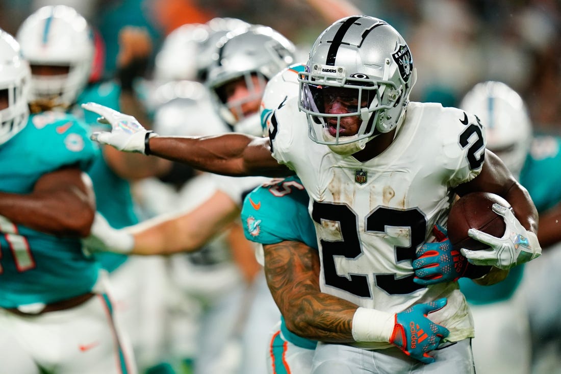 Aug 20, 2022; Miami Gardens, Florida, USA; Las Vegas Raiders running back Kenyan Drake (23) runs against the Miami Dolphins during the second quarter at Hard Rock Stadium. Mandatory Credit: Rich Storry-USA TODAY Sports