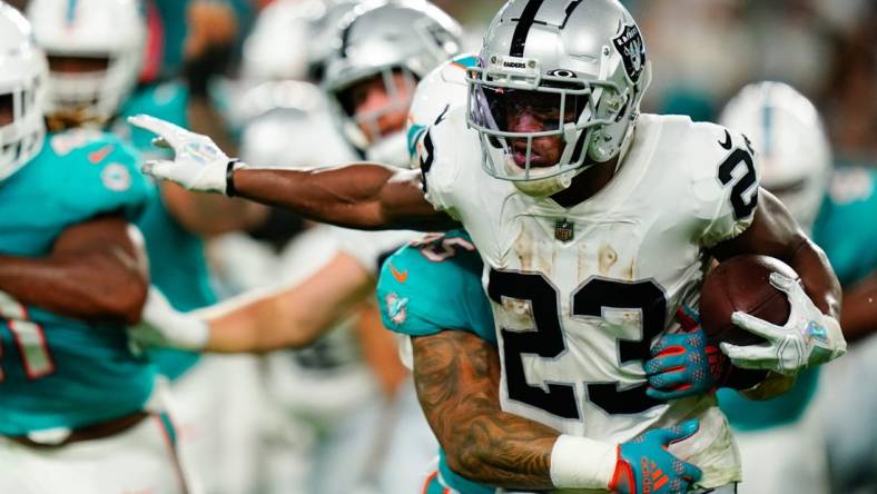 Aug 20, 2022; Miami Gardens, Florida, USA; Las Vegas Raiders running back Kenyan Drake (23) runs against the Miami Dolphins during the second quarter at Hard Rock Stadium. Mandatory Credit: Rich Storry-USA TODAY Sports