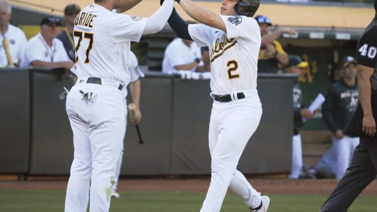 Aug 20, 2022; Oakland, California, USA; Oakland Athletics second baseman Jonah Bride (77) and shortstop Nick Allen (2) high five after being batted in against the Seattle Mariners during the fifth inning at RingCentral Coliseum. Mandatory Credit: Kelley L Cox-USA TODAY Sports