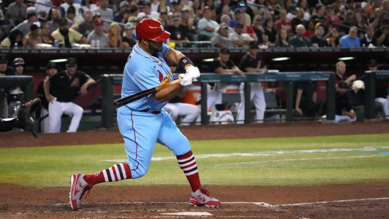 Aug 20, 2022; Phoenix, Arizona, USA; St. Louis Cardinals designated hitter Albert Pujols (5) hits a solo home run against the Arizona Diamondbacks during the fourth inning at Chase Field. Mandatory Credit: Joe Camporeale-USA TODAY Sports