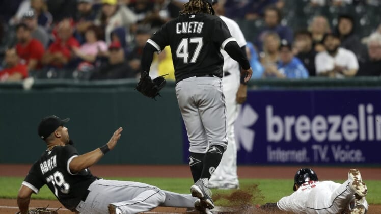 Aug 20, 2022; Cleveland, Ohio, USA; Chicago White Sox first baseman Jose Abreu (79) slides to first base to force out Cleveland Guardians Andres Gimenez (0) as pitcher Johnny Cueto jumps out of the way in the second inning at Progressive Field. Mandatory Credit: Aaron Josefczyk-USA TODAY Sports