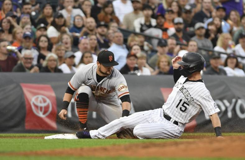 Aug 20, 2022; Denver, Colorado, USA; (Editors Notes: Caption Correction)  Colorado Rockies right fielder Randal Grichuk (15) is tagged out by San Francisco Giants third baseman J.D. Davis  (7) during the third inning at Coors Field. Mandatory Credit: John Leyba-USA TODAY Sports