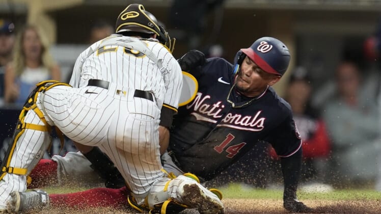 Aug 20, 2022; San Diego, California, USA;  Washington Nationals third baseman Ildemaro Vargas (14) is tagged out at home plate by San Diego Padres catcher Austin Nola (26) during the fifth inning at Petco Park. Mandatory Credit: Ray Acevedo-USA TODAY Sports