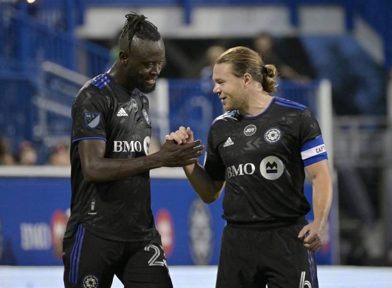 Aug 20, 2022; Montreal, Quebec, CAN; CF Montreal forward Kei Kamara (23) celebrates with midfielder Samuel Piette (6) after scoring a goal against the New England Revolution during the first half at Stade Saputo. Mandatory Credit: Eric Bolte-USA TODAY Sports