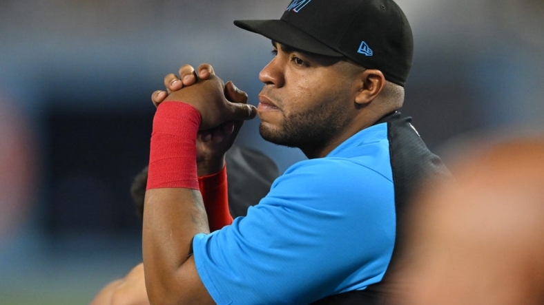 Aug 20, 2022; Los Angeles, California, USA;  Miami Marlins first baseman Jesus Aguilar (99) looks on from the dugout during the game against the Los Angeles Dodgers at Dodger Stadium. Mandatory Credit: Jayne Kamin-Oncea-USA TODAY Sports