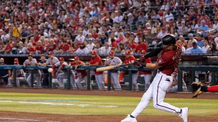 Aug 21, 2022; Phoenix, Arizona, USA; Arizona Diamondbacks outfielder Jake McCarthy (30) singles a line drive to the center during the second inning against the St. Louis Cardinals at Chase Field. Mandatory Credit: Allan Henry-USA TODAY Sports