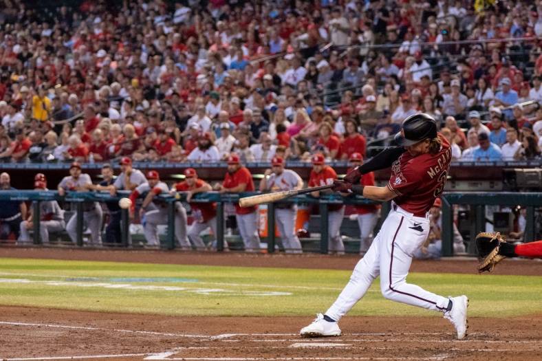 Aug 21, 2022; Phoenix, Arizona, USA; Arizona Diamondbacks outfielder Jake McCarthy (30) singles a line drive to the center during the second inning against the St. Louis Cardinals at Chase Field. Mandatory Credit: Allan Henry-USA TODAY Sports