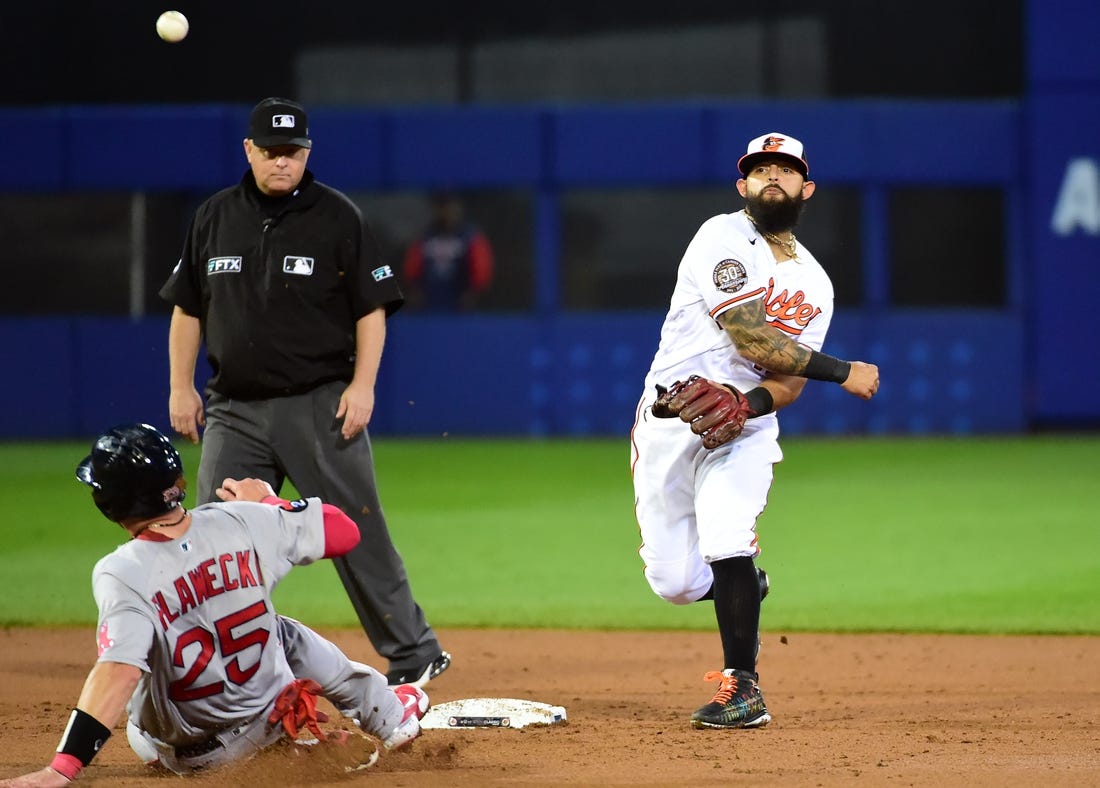 Aug 21, 2022; Williamsport, Pennsylvania, USA; Baltimore Orioles second baseman Rougned Odor (12) turns a double play over Boston Red Sox catcher Kevin Plawecki (25) in the third inning at Muncy Bank Ballpark at Historic Bowman Field. Mandatory Credit: Evan Habeeb-USA TODAY Sports