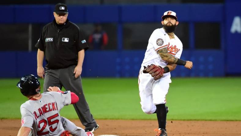 Aug 21, 2022; Williamsport, Pennsylvania, USA; Baltimore Orioles second baseman Rougned Odor (12) turns a double play over Boston Red Sox catcher Kevin Plawecki (25) in the third inning at Muncy Bank Ballpark at Historic Bowman Field. Mandatory Credit: Evan Habeeb-USA TODAY Sports