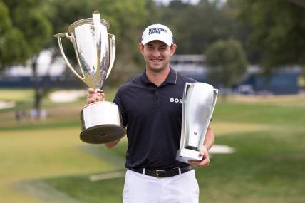 Aug 21, 2022; Wilmington, Delaware, USA; Patrick Cantlay poses with the BMW and Western Golf Association trophies after winning the BMW Championship golf tournament. Mandatory Credit: Bill Streicher-USA TODAY Sports