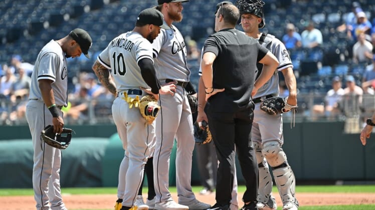 Aug 22, 2022; Kansas City, Missouri, USA;  Chicago White Sox starting pitcher Michael Kopech (34) talks with a trainer during the first inning against the Kansas City Royals at Kauffman Stadium. Mandatory Credit: Peter Aiken-USA TODAY Sports