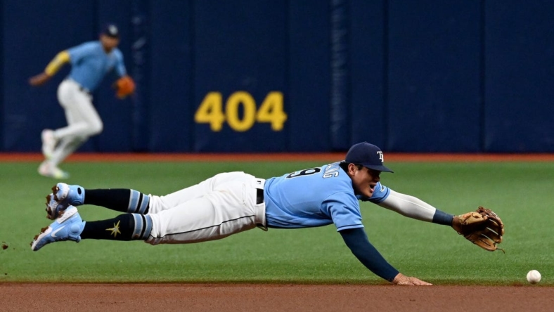 Aug 22, 2022; St. Petersburg, Florida, USA;  Tampa Bay Rays second baseman Yu Chang (9) dives for a ground ball in the first inning against the Los Angeles Angels  at Tropicana Field. Mandatory Credit: Jonathan Dyer-USA TODAY Sports