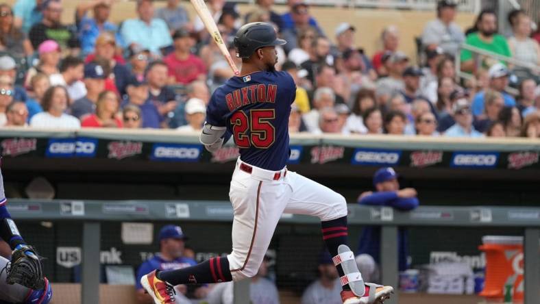 Aug 22, 2022; Minneapolis, Minnesota, USA; Minnesota Twins center fielder Byron Buxton (25) hits a single during the third inning against the Texas Rangers at Target Field. Mandatory Credit: Jordan Johnson-USA TODAY Sports