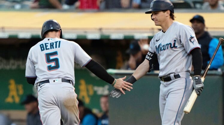 Aug 22, 2022; Oakland, California, USA; Miami Marlins second baseman Jon Berti (5) celebrates with center fielder JJ Bleday (67) during the third inning against the Oakland Athletics at RingCentral Coliseum. Mandatory Credit: Stan Szeto-USA TODAY Sports