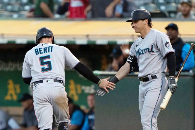 Aug 22, 2022; Oakland, California, USA; Miami Marlins second baseman Jon Berti (5) celebrates with center fielder JJ Bleday (67) during the third inning against the Oakland Athletics at RingCentral Coliseum. Mandatory Credit: Stan Szeto-USA TODAY Sports