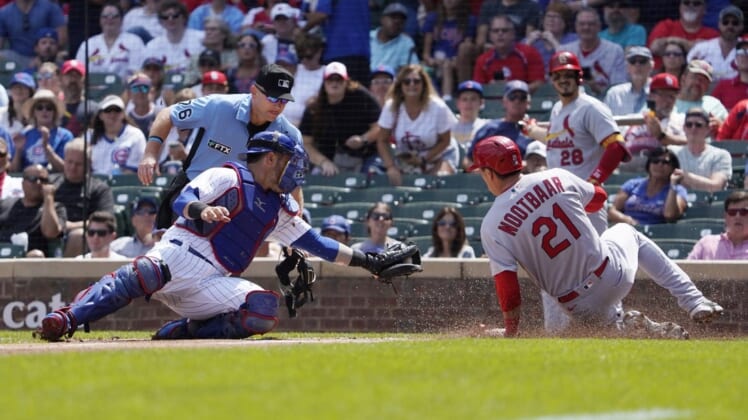Aug 23, 2022; Chicago, Illinois, USA; Chicago Cubs catcher Yan Gomes (7) tags out St. Louis Cardinals right fielder Lars Nootbaar (21) during the first inning at Wrigley Field. Mandatory Credit: David Banks-USA TODAY Sports