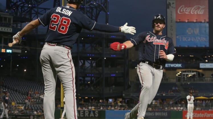 Aug 23, 2022; Pittsburgh, Pennsylvania, USA; Atlanta Braves first baseman Matt Olson (28) greets left fielder Robbie Grossman (right) after Grossman scored a run against the Pittsburgh Pirates during the fifth inning at PNC Park. Mandatory Credit: Charles LeClaire-USA TODAY Sports