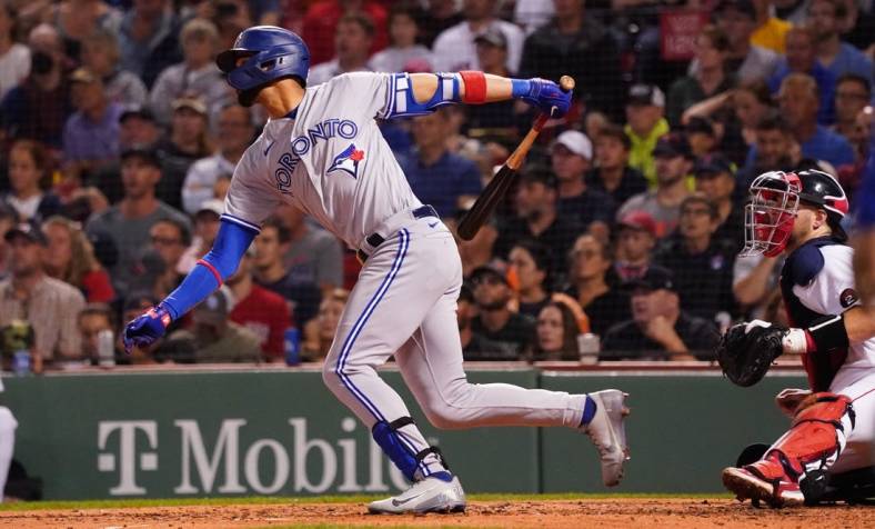 Aug 23, 2022; Boston, Massachusetts, USA; Toronto Blue Jays left fielder Lourdes Gurriel Jr. (13) hits a double to drive in a run against the Boston Red Sox in the third inning at Fenway Park. Mandatory Credit: David Butler II-USA TODAY Sports