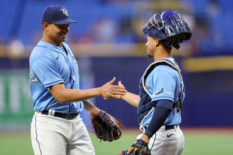 Aug 23, 2022; St. Petersburg, Florida, USA;  Tampa Bay Rays catcher Francisco Mejia (21) congratulates catcher Christian Bethancourt (14) after pitching the ninth inning against the Los Angeles Angels at Tropicana Field. Mandatory Credit: Nathan Ray Seebeck-USA TODAY Sports