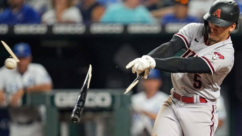 Aug 23, 2022; Kansas City, Missouri, USA; Arizona Diamondbacks center fielder Alek Thomas (5) breaks his bat as he hits a single against the Kansas City Royals during the sixth inning at Kauffman Stadium. Mandatory Credit: Jay Biggerstaff-USA TODAY Sports