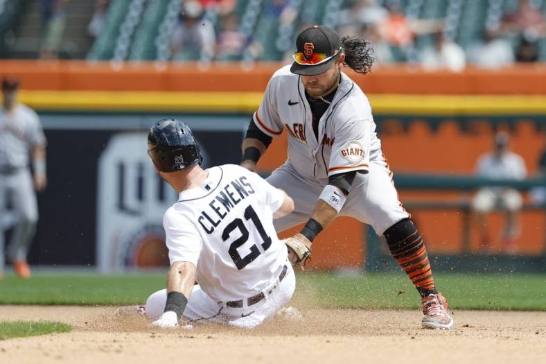 Aug 24, 2022; Detroit, Michigan, USA;  Detroit Tigers first baseman Kody Clemens (21) slides in safe at second ahead of the tag by San Francisco Giants shortstop Brandon Crawford (35) in the fourth inning at Comerica Park. Mandatory Credit: Rick Osentoski-USA TODAY Sports