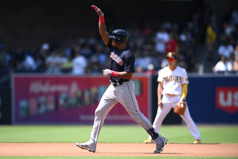 Aug 24, 2022; San Diego, California, USA; Cleveland Guardians right fielder Oscar Gonzalez (left) gestures while rounding the bases after hitting a home run against the San Diego Padres during the fourth inning at Petco Park. Mandatory Credit: Orlando Ramirez-USA TODAY Sports